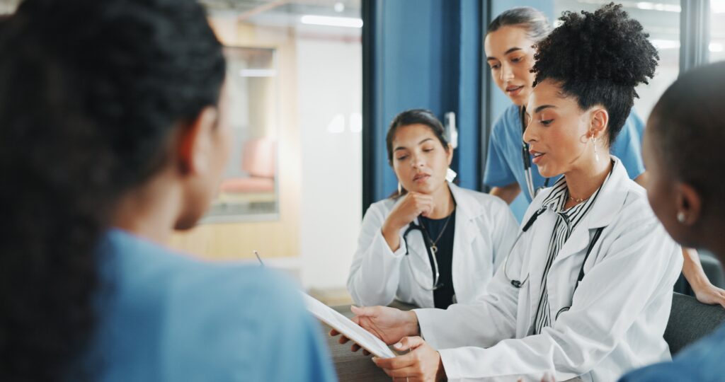 Doctors and nurses looking at a clipboard