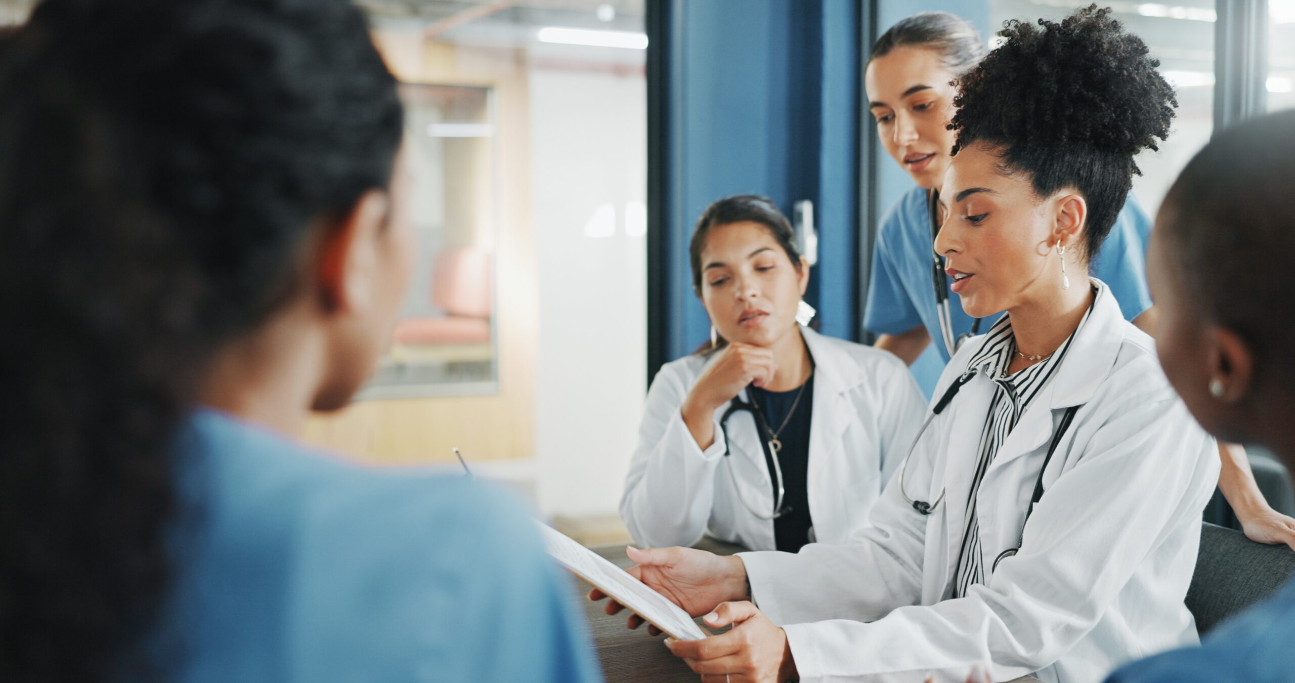 Doctors and nurses looking at a clipboard
