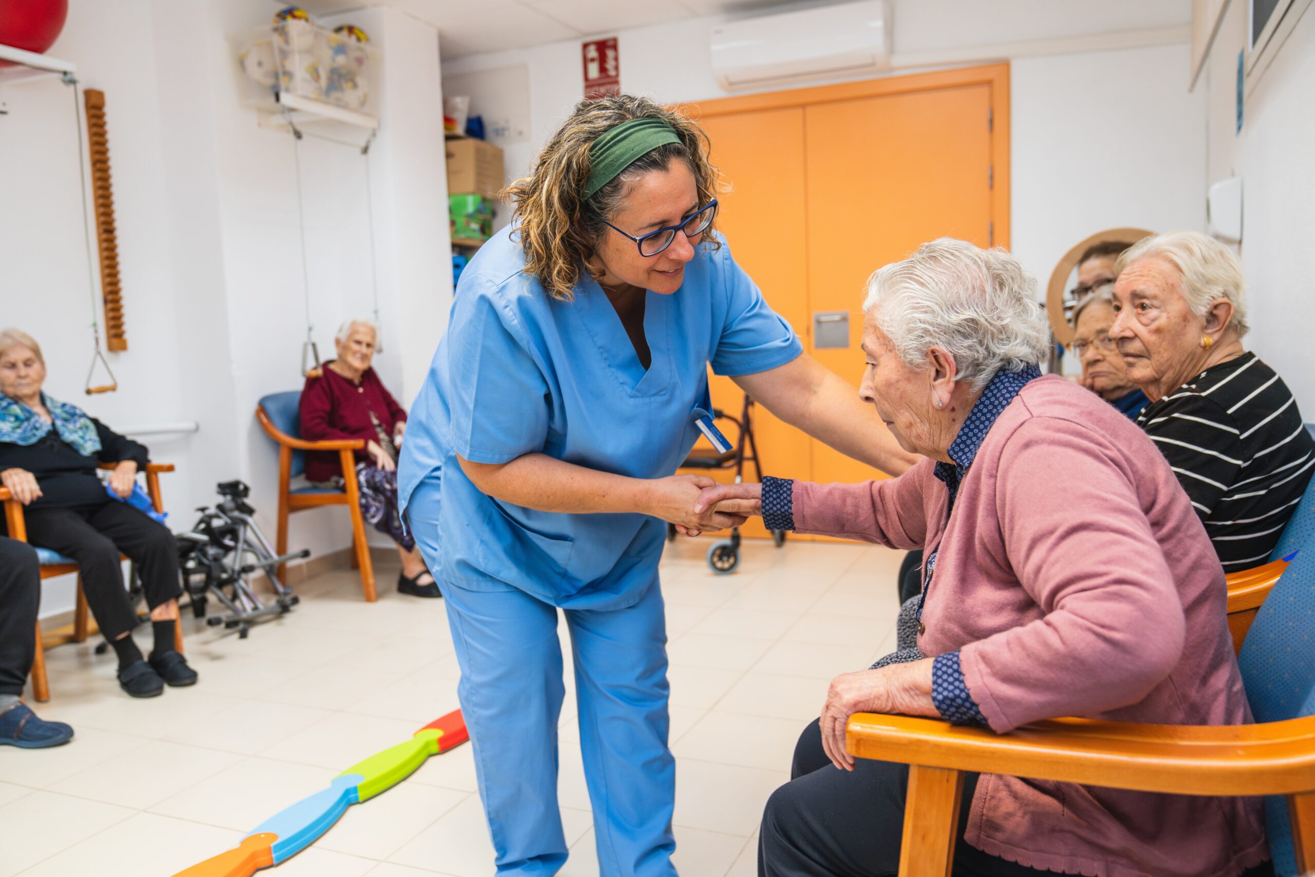 Care worker interacting with elderly residents